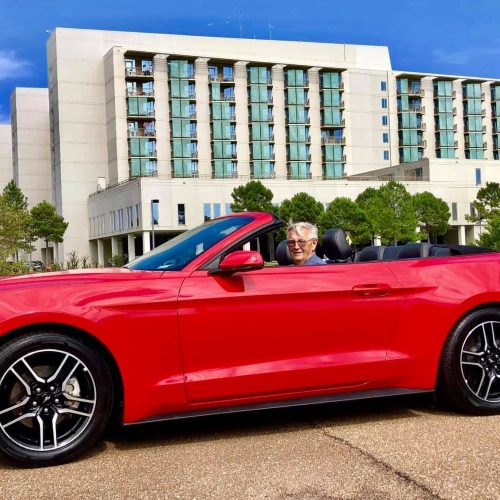 My Dad in his red convertible.